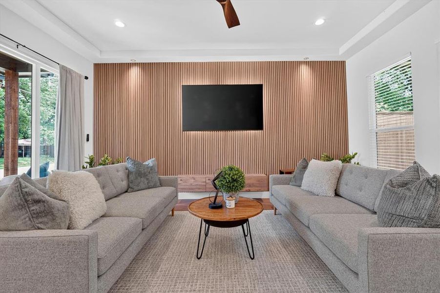 Living area featuring a slatted wood-finish accent wall with integrated cabinetry