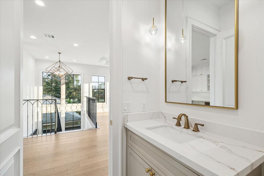 Powder bath adjacent to game room, convenient for entertaining*Picture is of a recently constructed home by the builder.  1519 Candlelight will be similar in quality, but these pictures are not meant to be an exact representation of the new home. Specs of home may change at sole discretion of the seller.