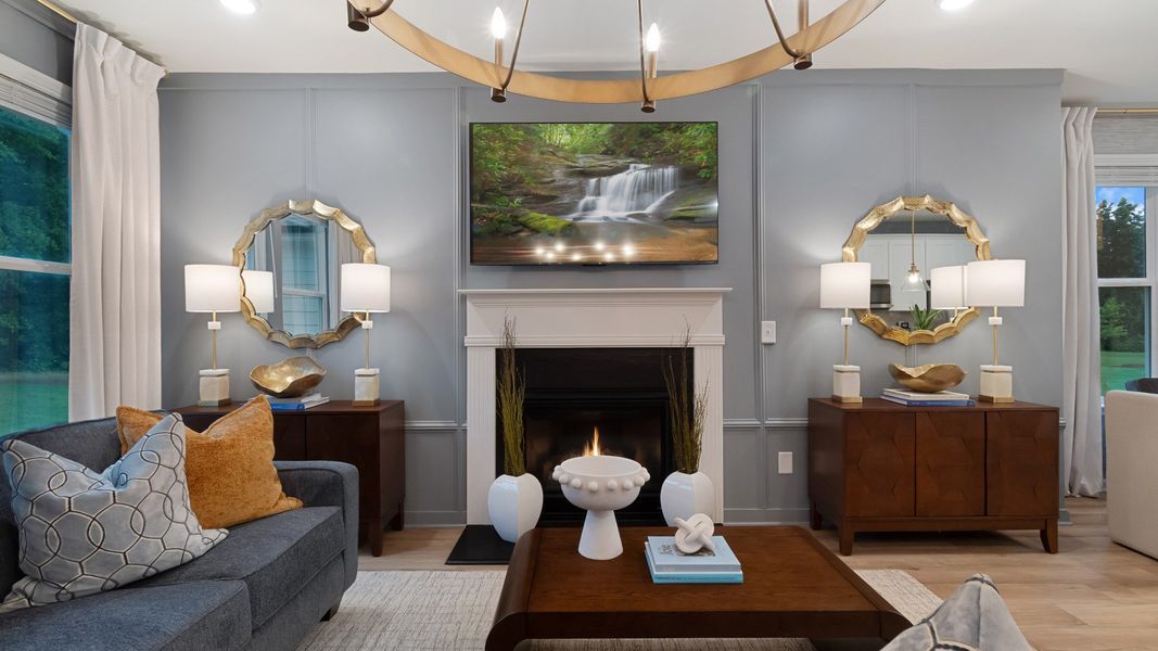 Inviting family room featuring LVP flooring and traditional fireplace with mantel