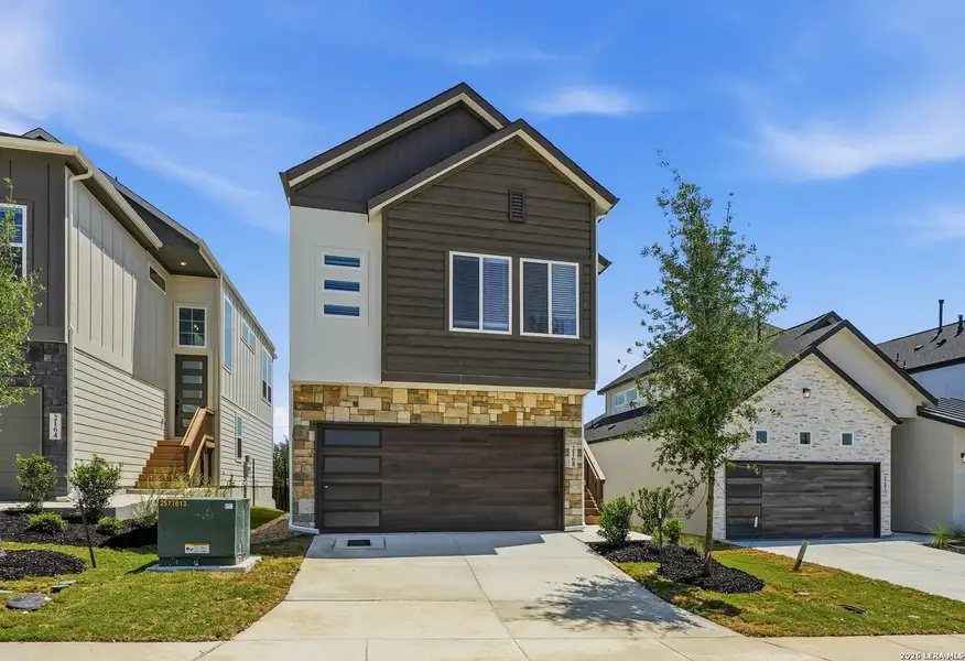 Front exterior of a new home in Prominence Urban, San Antonio, TX, highlighting curb appeal (Image 23).