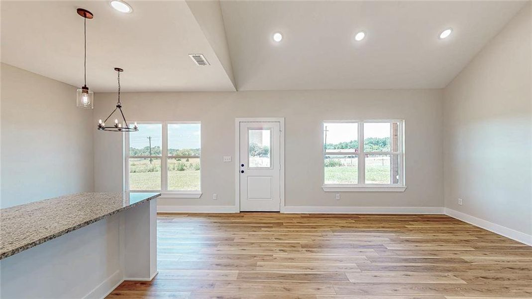 Foyer featuring light wood-style floors, a chandelier, and recessed lighting Foyer featuring light wood-style floors, a chandelier, and recessed lighting