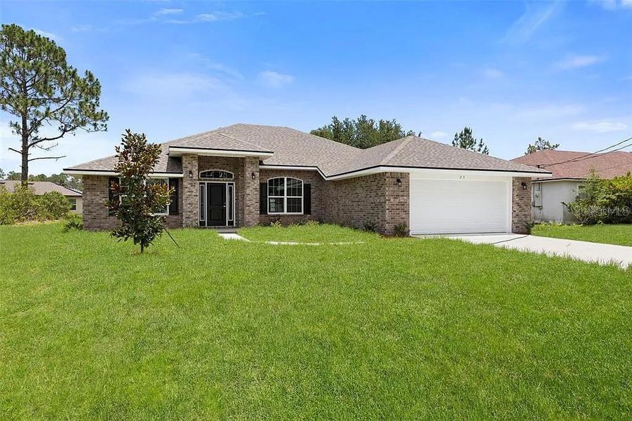 Front exterior of a new home in Palm Coast, Palm Coast, FL, highlighting curb appeal (Image 1). Front exterior of a new home in Palm Coast, Palm Coast, FL, highlighting curb appeal (Image 1).