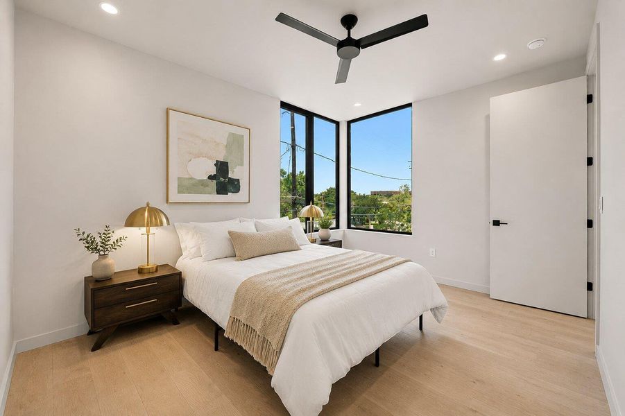 Natural light floods this inviting bedroom, highlighting the smooth wooden flooring and clean, minimalist aesthetic. Natural light floods this inviting bedroom, highlighting the smooth wooden flooring and clean, minimalist aesthetic.