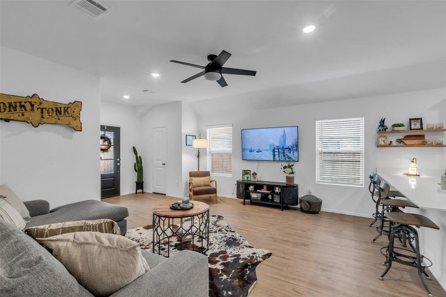 This pictures shows the entryway and the large family room. Plenty of room for family and friends. The floors are a pretty neutral color that will match anyone's design.