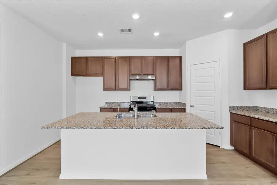 This spacious kitchen has it all—ample storage, generous counter space, and a layout that truly makes it the heart of the home.