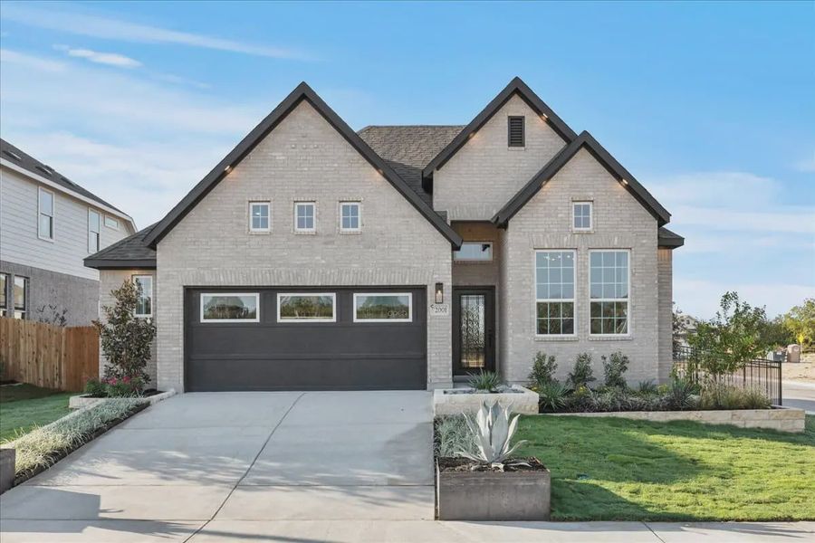 Front exterior of a new home in Stream Waters, Buda, TX, highlighting curb appeal (Image 20).