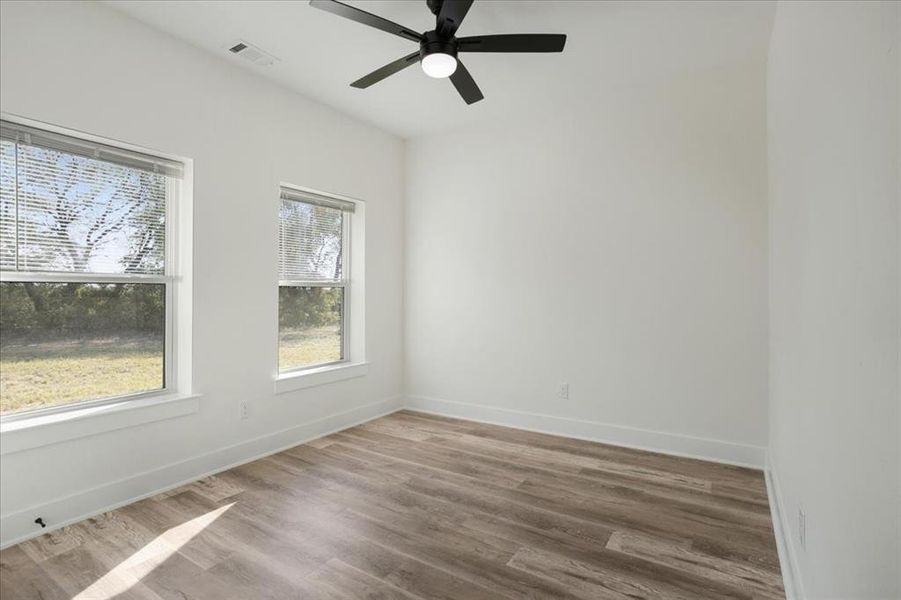Bedroom 2 with wood finished floors and ceiling fan