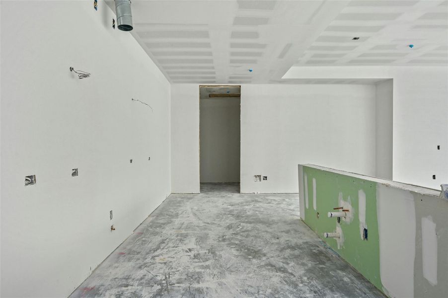 Empty room featuring unfinished concrete floors