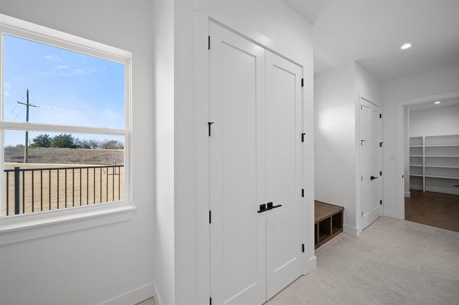 Hallway with recessed lighting and light tile patterned flooring