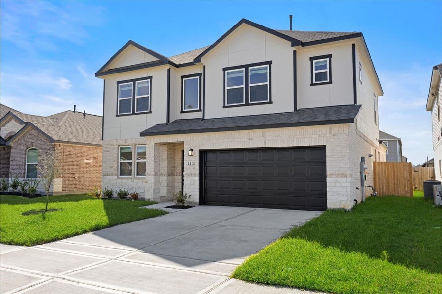 This two-story home features a modern design with a light-colored facade and dark accents. It has a spacious two-car garage and a neatly maintained front yard. The driveway is wide and leads up to the main entrance. The house has several windows that provide ample natural light. This two-story home features a modern design with a light-colored facade and dark accents. It has a spacious two-car garage and a neatly maintained front yard. The driveway is wide and leads up to the main entrance. The house has several windows that provide ample natural light.