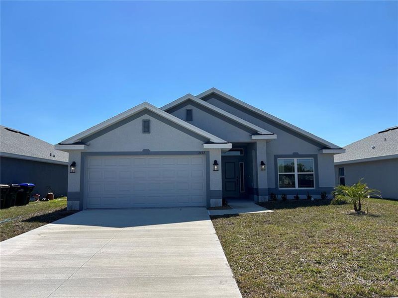 Front exterior of a new home in Watercress Cove, North Port, FL, highlighting curb appeal (Image 1). Front exterior of a new home in Watercress Cove, North Port, FL, highlighting curb appeal (Image 1).