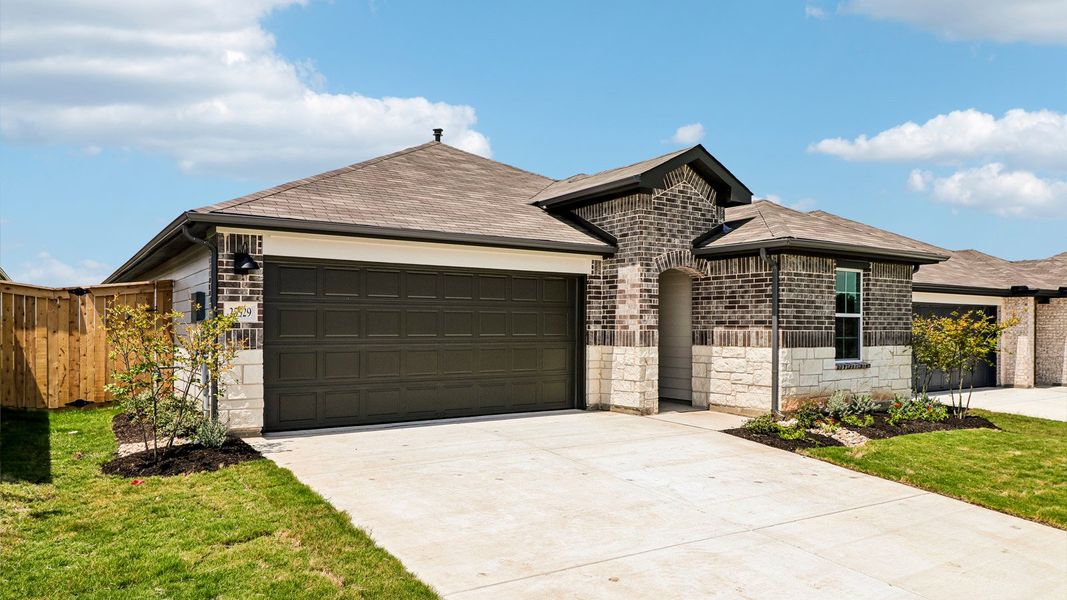 Front exterior of a new home in Briarwood, Elgin, TX, highlighting curb appeal (Image 2). Front exterior of a new home in Briarwood, Elgin, TX, highlighting curb appeal (Image 2).