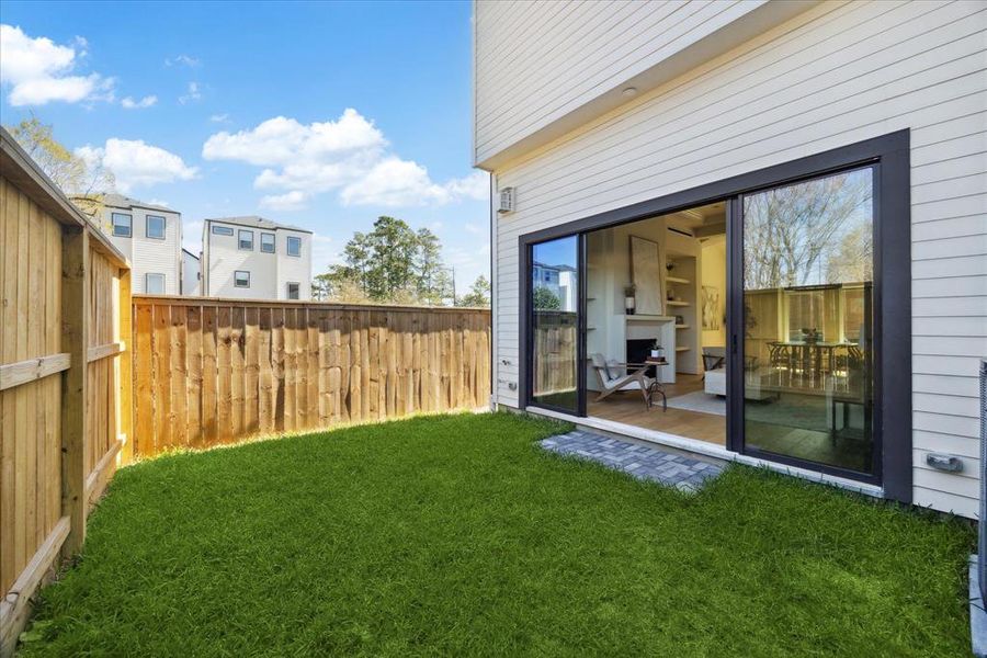 Outdoor Oasis - Accessed through large sliding glass doors from the living room.  This space is ideal for lounging, grilling, outdoor dining and relaxing. Your secluded sanctuary for play with family and pets.