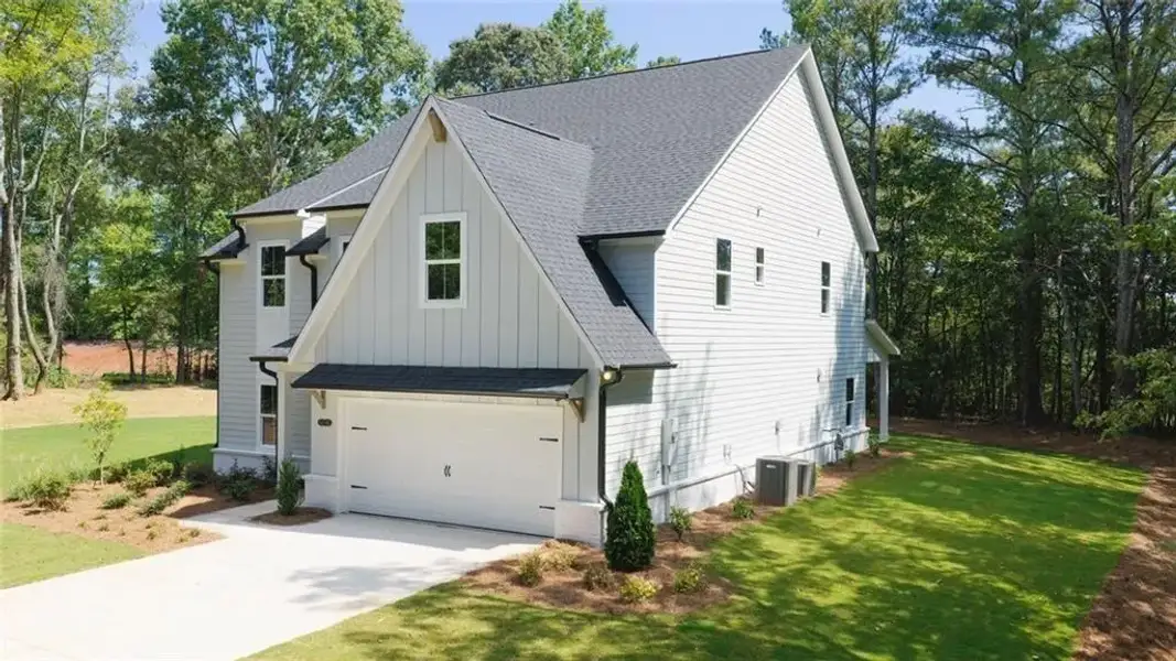 Front exterior of a new home in , Flowery Branch, GA, highlighting curb appeal (Image 26).