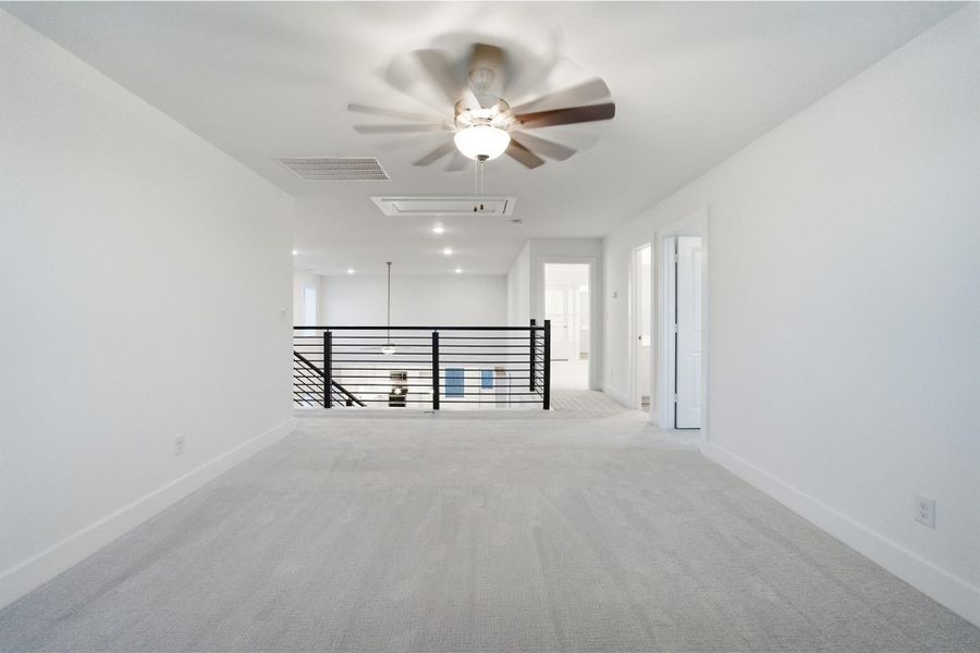Empty room featuring light carpet, a ceiling fan, and recessed lighting