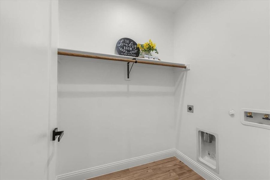 Laundry area featuring light wood-style floors, hookup for an electric dryer, gas dryer hookup, and washer hookup