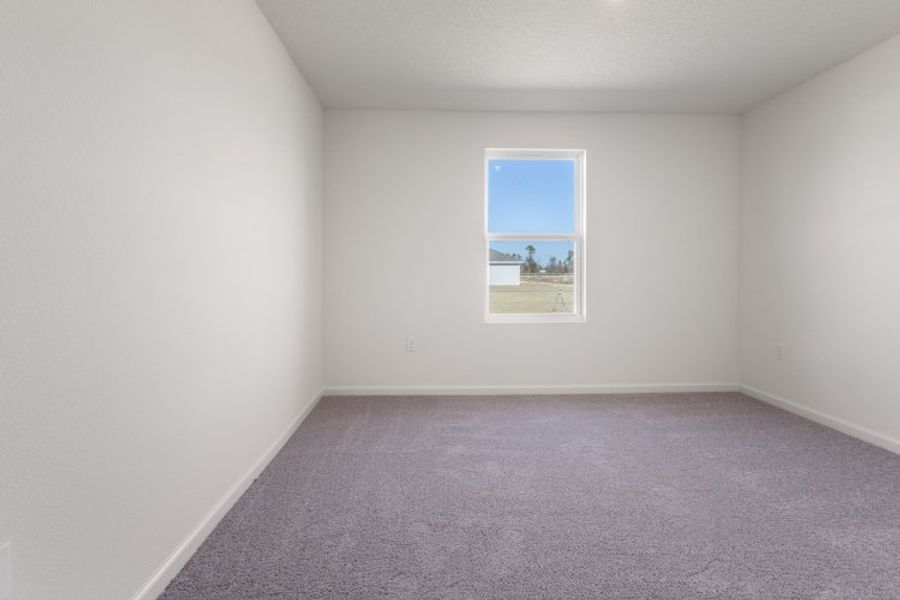 A room with a window and a carpet. A room with a window and a carpet.