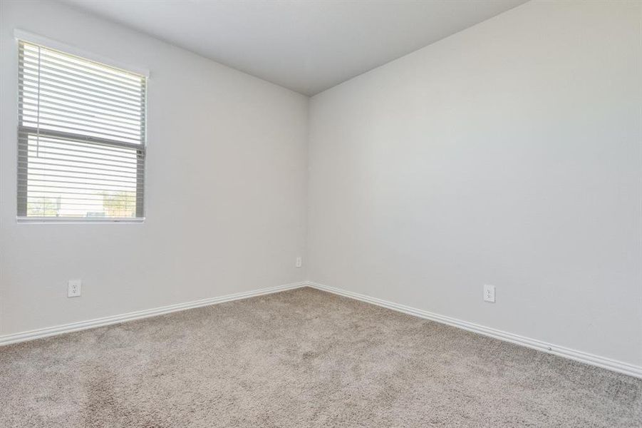 Carpeted empty room with baseboards