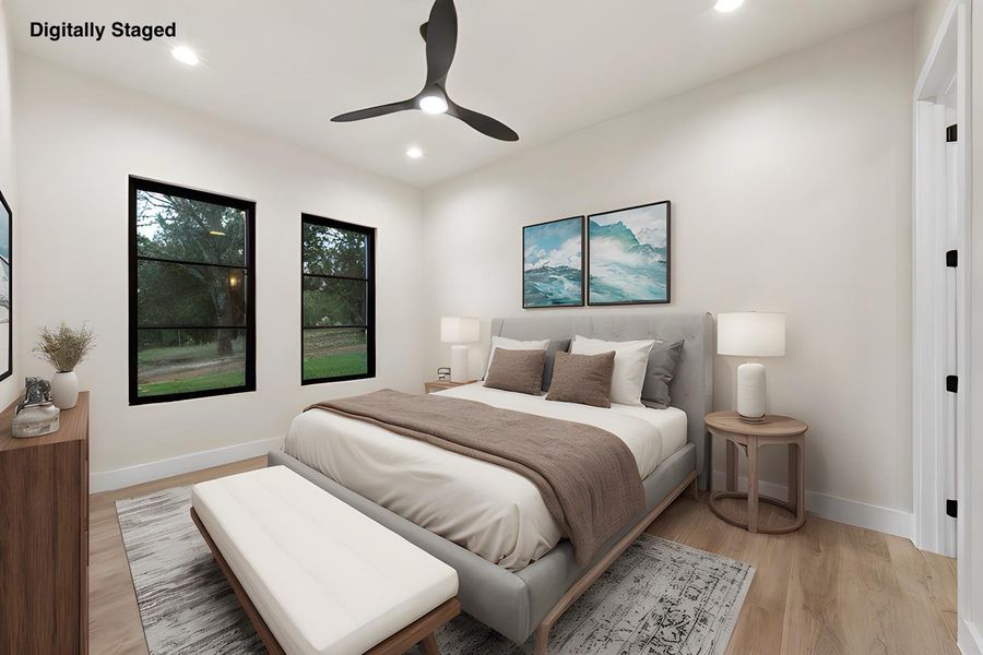 A well-lit bedroom features hardwood flooring and a contemporary ceiling fan, offering a comfortable and serene retreat.