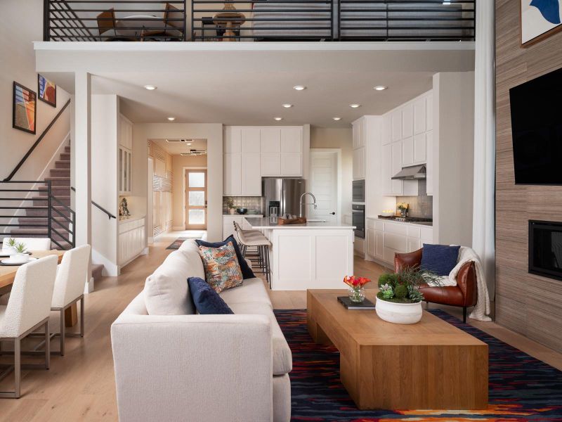 Living room featuring a large fireplace, light wood-type flooring, and recessed lighting