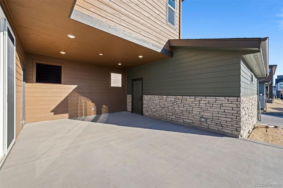 Exterior details and patio area of a home in Painted Prairie, Aurora (Image 28).
