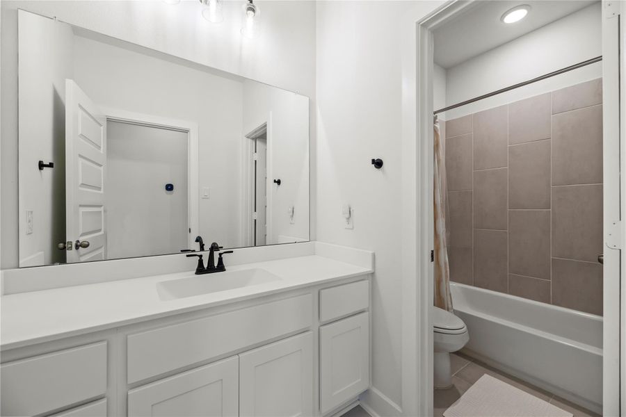 The second full bath upstairs features a modern vanity with excellent storage and a separate water closet with the toilet and tub/shower, making it easy to share the space comfortably.