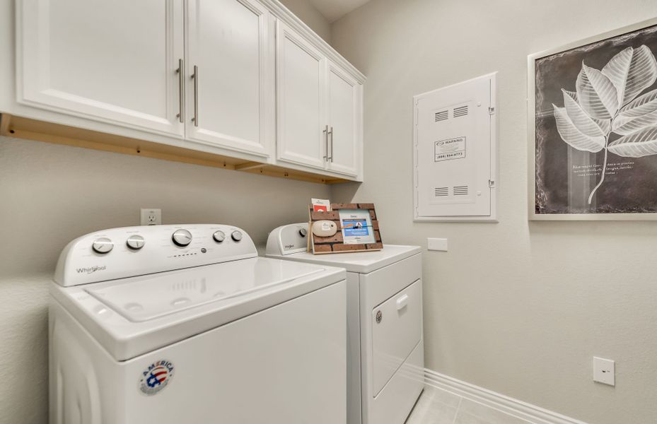 Spacious utility room with tile-flooring and built-in shelving