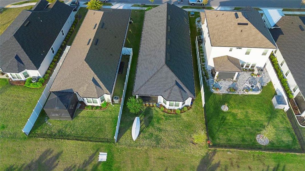 An aerial view of the property showcases its prime location, highlighting the spacious lot, serene reserve in the rear, and the well-planned layout of the home and surrounding areas.