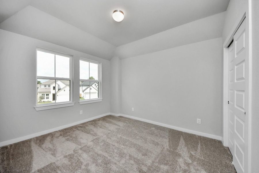 Secondary bedroom features plush carpeting, large windows that let in plenty of natural light, bright paint, and spacious closets. Secondary bedroom features plush carpeting, large windows that let in plenty of natural light, bright paint, and spacious closets.