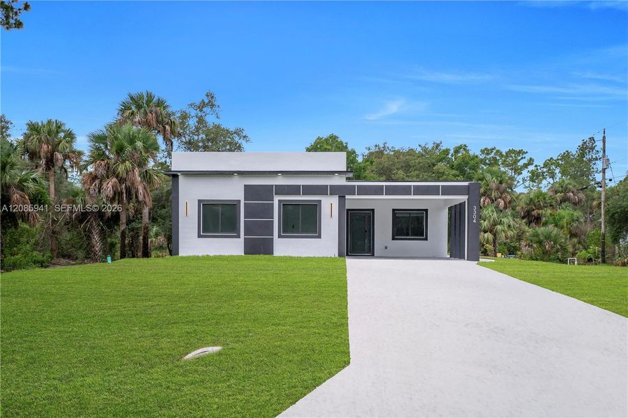 Front exterior of a new home in , Lehigh Acres, FL, highlighting curb appeal (Image 27). Front exterior of a new home in , Lehigh Acres, FL, highlighting curb appeal (Image 27).