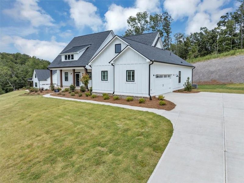 Front exterior of a new home in , Ball Ground, GA, highlighting curb appeal (Image 26).