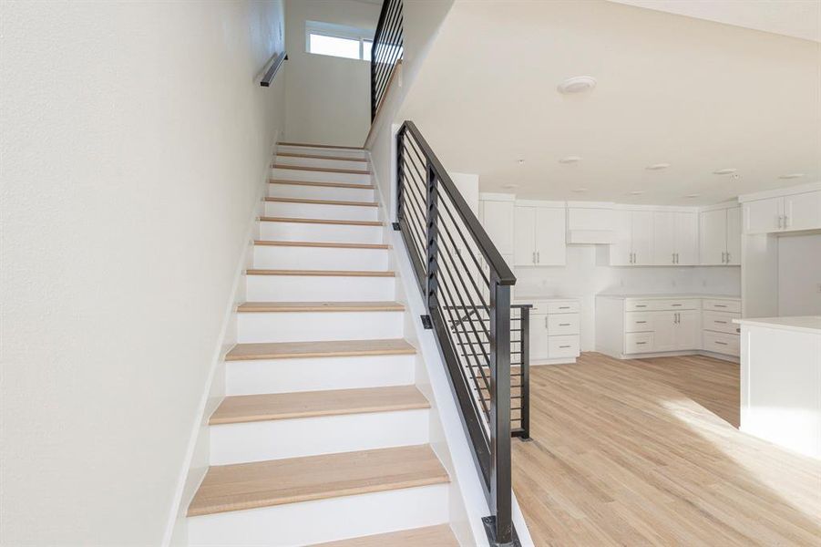 Staircase featuring wood finished floors