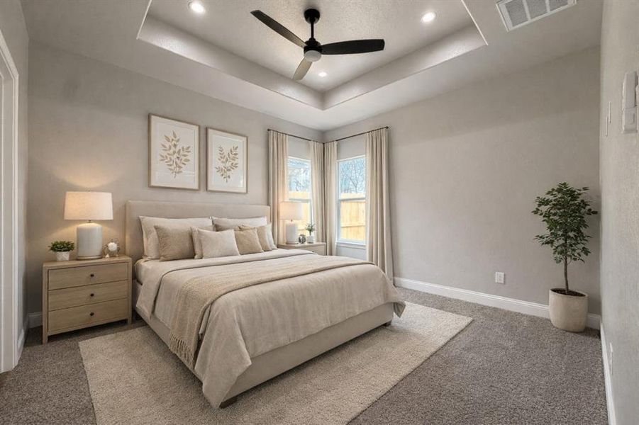 Bedroom with carpet floors, a ceiling fan, recessed lighting, and a raised ceiling