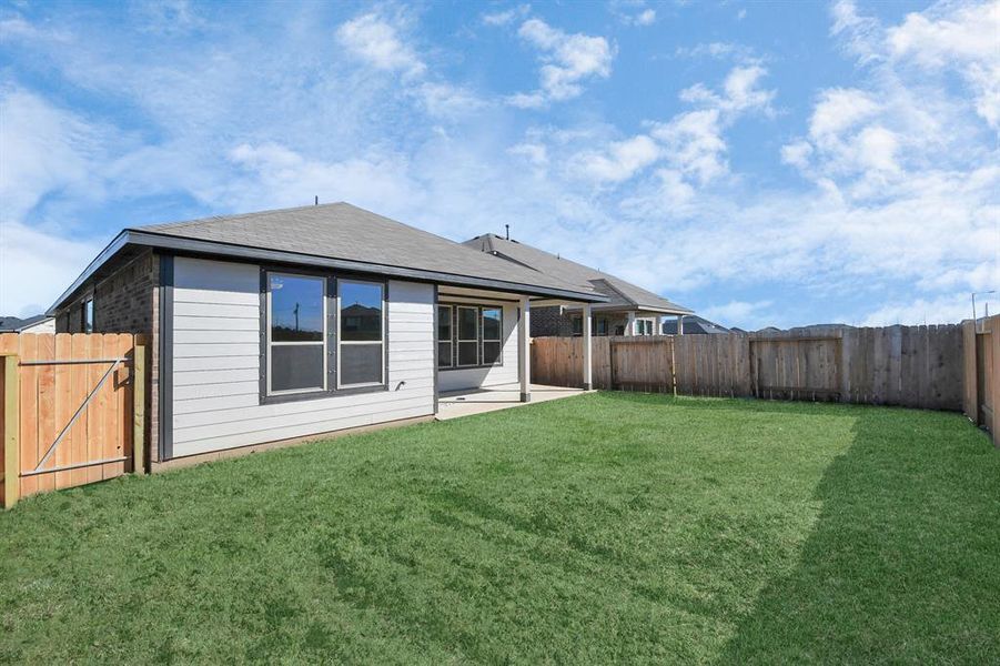 Come and see this spacious backyard with its beautiful covered patio.