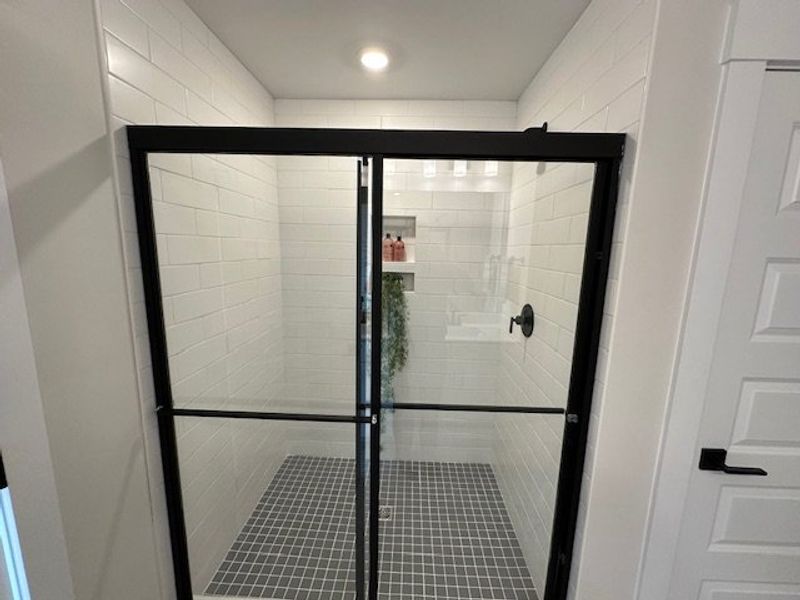 This sleek shower features modern tiling and pract