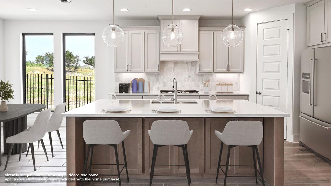 Kitchen with appliances with stainless steel finishes, recessed lighting, light countertops, tasteful backsplash, and an island with sink Kitchen with appliances with stainless steel finishes, recessed lighting, light countertops, tasteful backsplash, and an island with sink