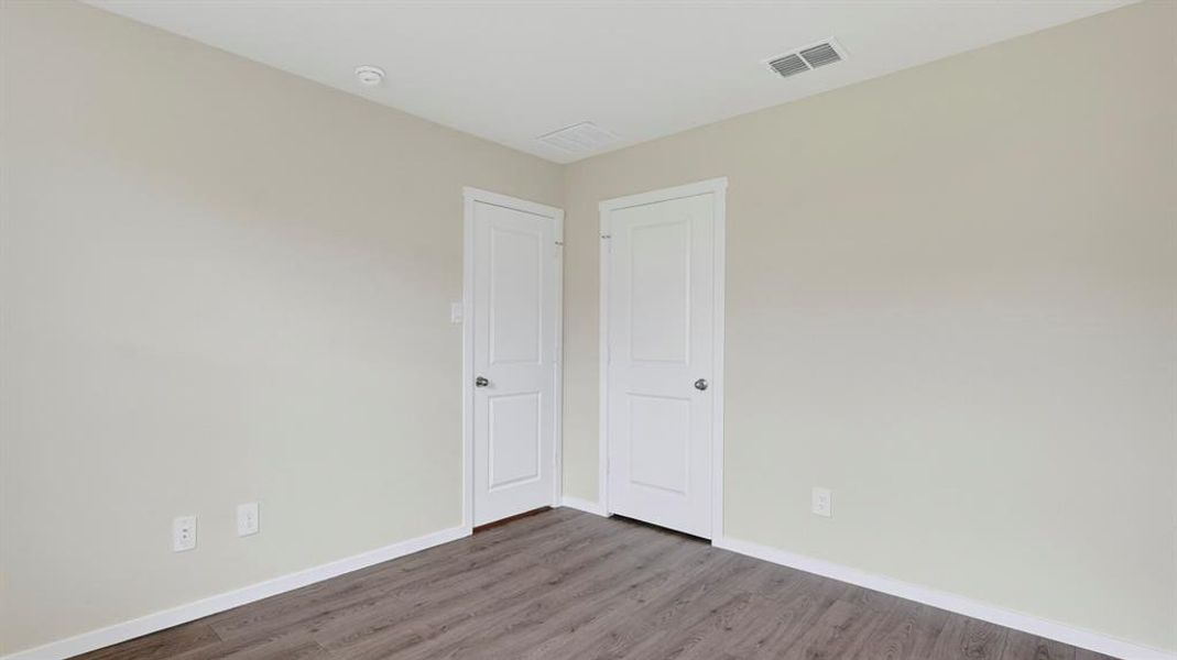 Neutral-toned walls complement wood-finish flooring