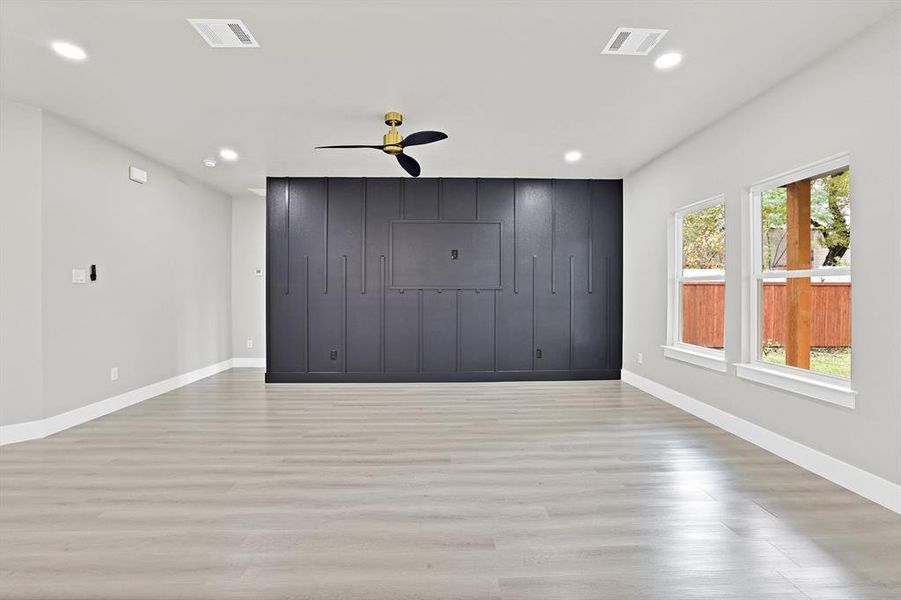 Unfurnished bedroom with ceiling fan and light hardwood / wood-style floors