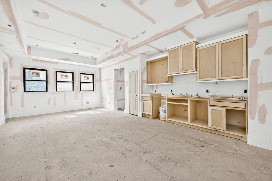 Game room is equipped with a wet bar and hardwood floors. Built with integrity from open web trusses for a stiff squeak-free base.