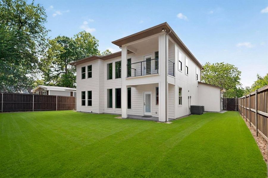 Rear view of property featuring a fenced backyard, a balcony, and a patio area Rear view of property featuring a fenced backyard, a balcony, and a patio area