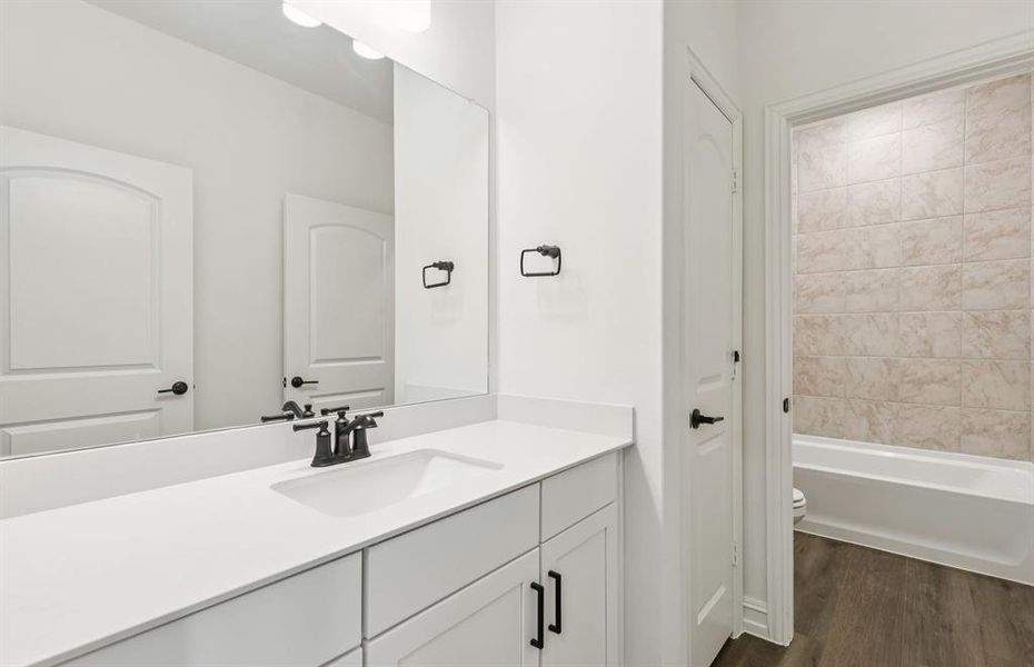 Secondary bathroom featuring modern upgrades and finishes *Model representation Secondary bathroom featuring modern upgrades and finishes *Model representation
