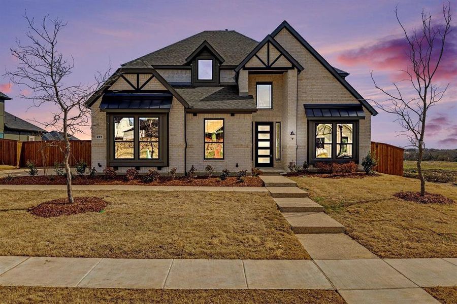 Front exterior of a new home in Malabar Hill, Prosper, TX, highlighting curb appeal (Image 2). Front exterior of a new home in Malabar Hill, Prosper, TX, highlighting curb appeal (Image 2).