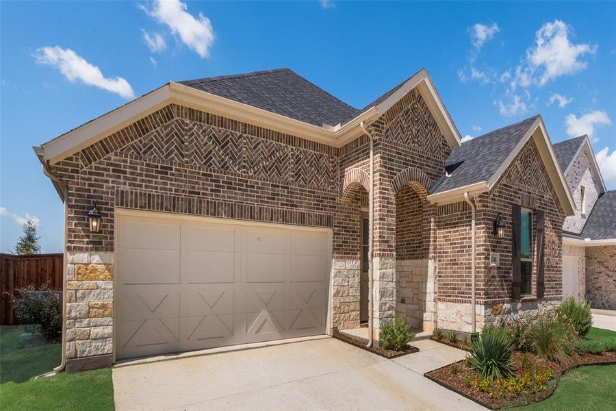 Front exterior of a new home in Spiritas Ranch, Little Elm, TX, highlighting curb appeal (Image 1).