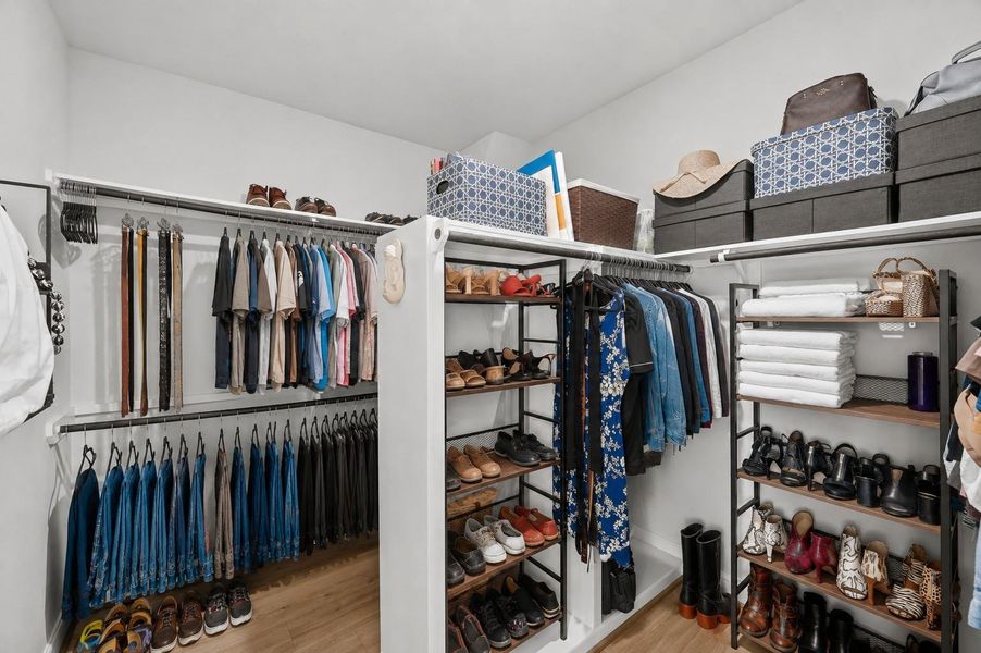 Oversized primary walk-in closet, expanded and upgraded by the seller, with abundant hanging space and storage.