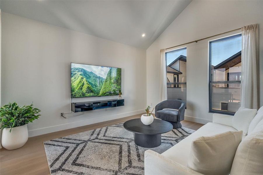 Model Home Gameroom with lofted ceiling, light wood-type flooring, and recessed lighting
