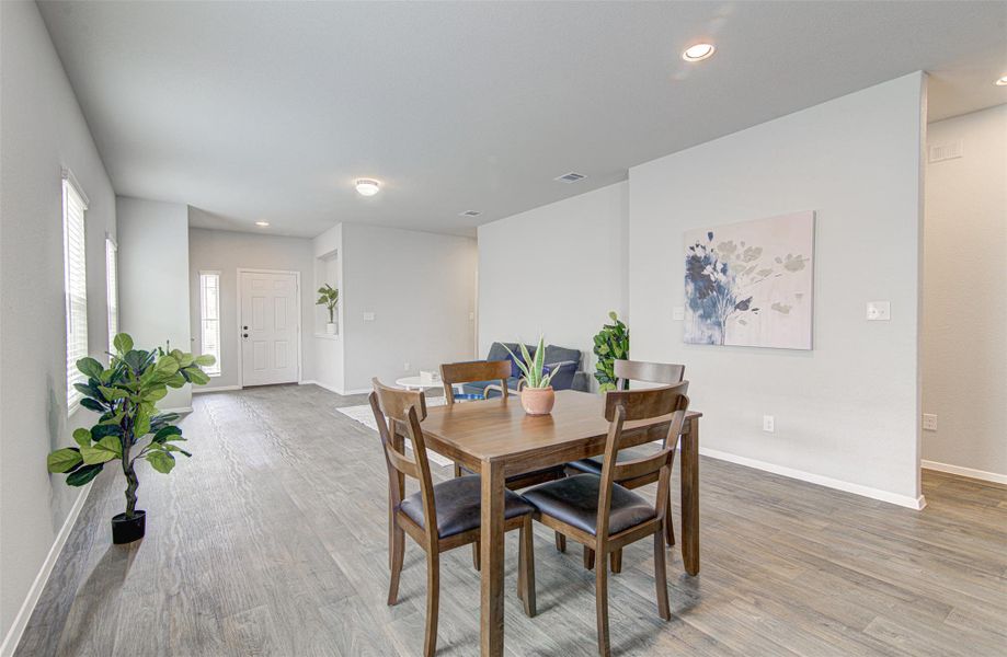 Hardwood-style flooring extends from the inviting entryway through the combined dining and living spaces. Hardwood-style flooring extends from the inviting entryway through the combined dining and living spaces.
