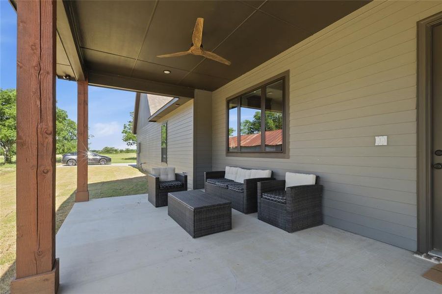 Covered patio featuring a wood-finish ceiling fan, recessed lighting, and exposed wooden structural posts