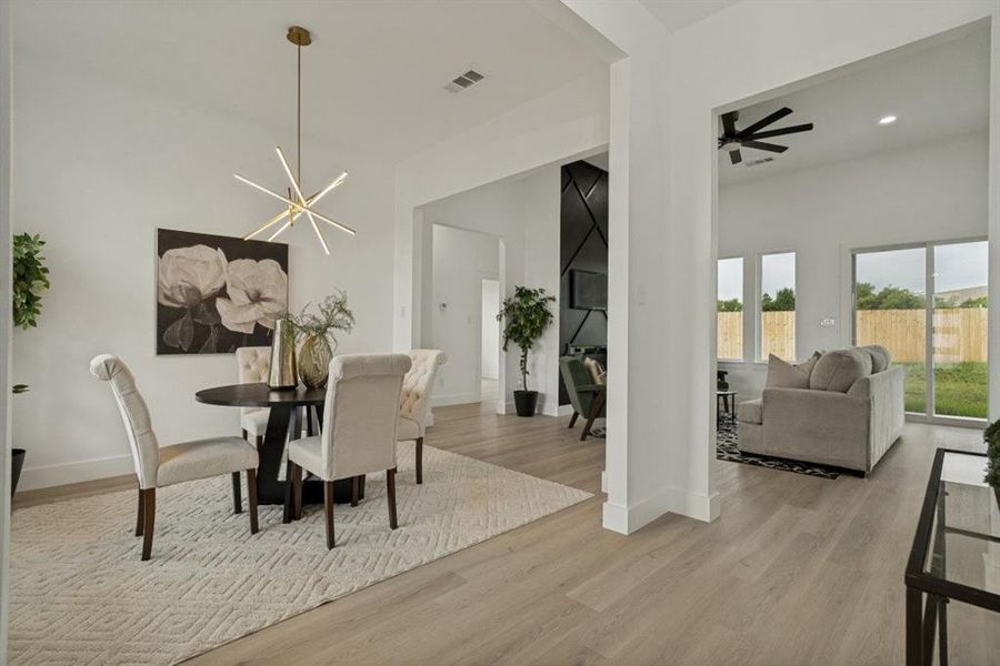 Light-toned wood-finish flooring extends throughout this open-concept interior Light-toned wood-finish flooring extends throughout this open-concept interior