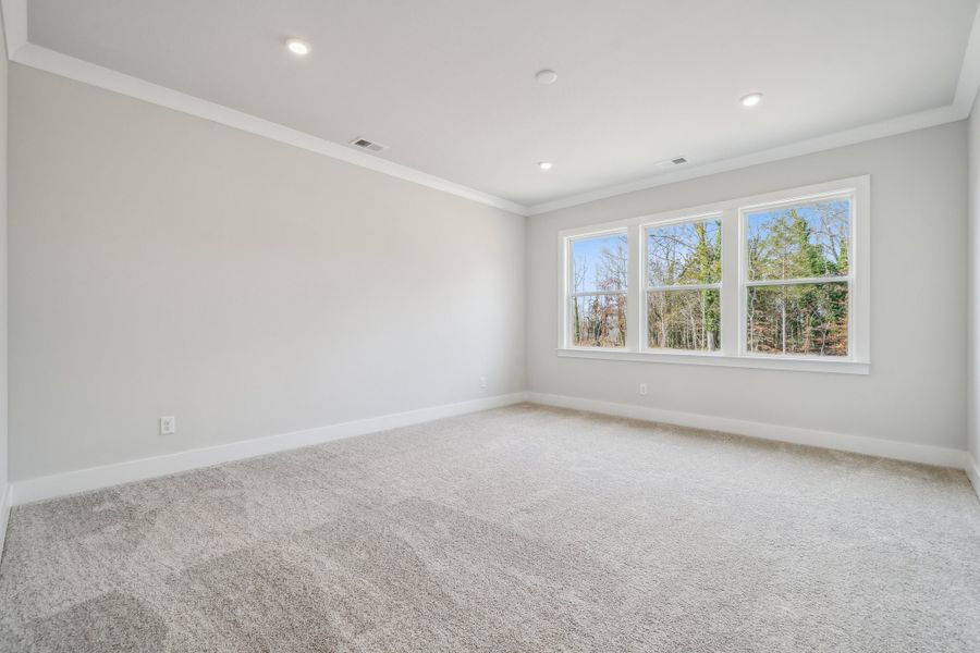 A room with a window and a carpet.