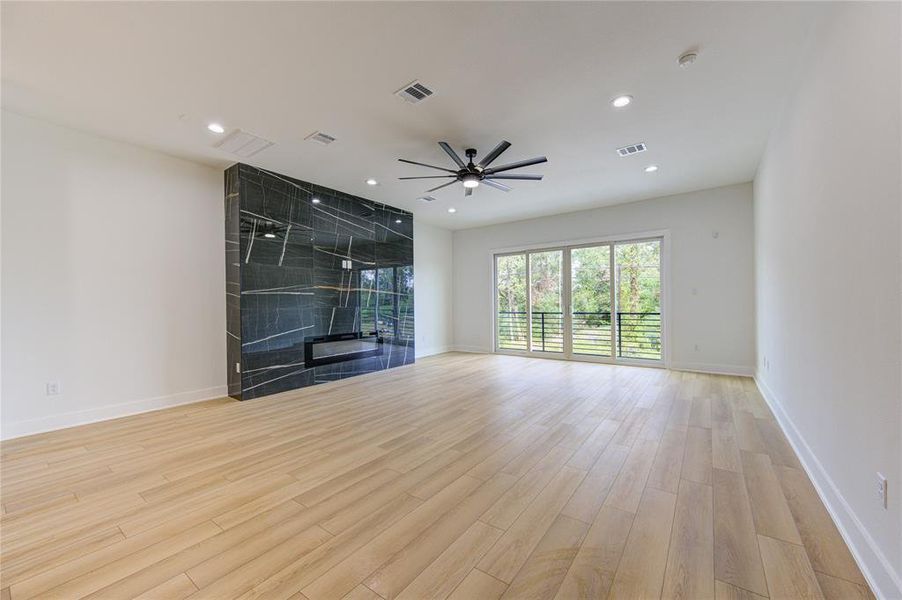 Balcony off of the living room with an electric fireplace